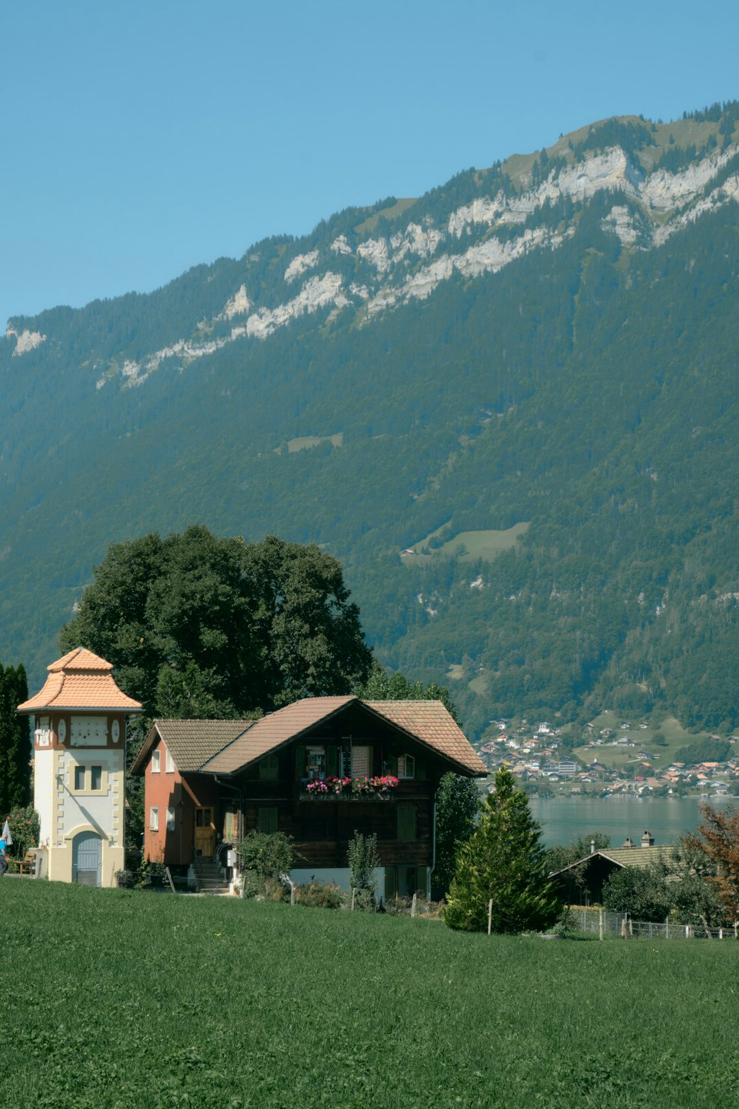 Facade of an elegant Swiss lakeside villa surrounded by greenery